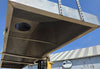 Interior of the metal canopy showing the structural paneling, smooth walls, and central exhaust port.