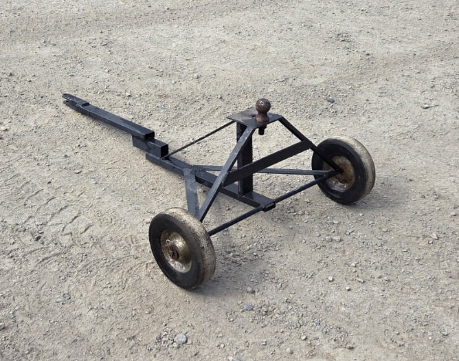 Custom welded steel manual trailer dolly showing A-frame base, two wheels, center ball hitch, and extended handle.