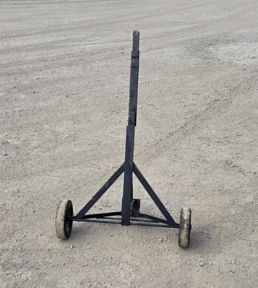 Trailer dolly with its 48-inch long handle folded into a vertical upright position for compact storage.