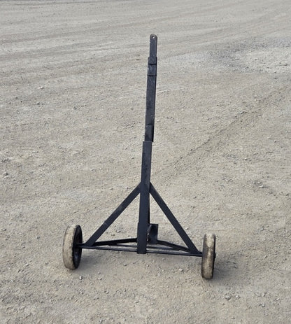 Trailer dolly with its 48-inch long handle folded into a vertical upright position for compact storage.