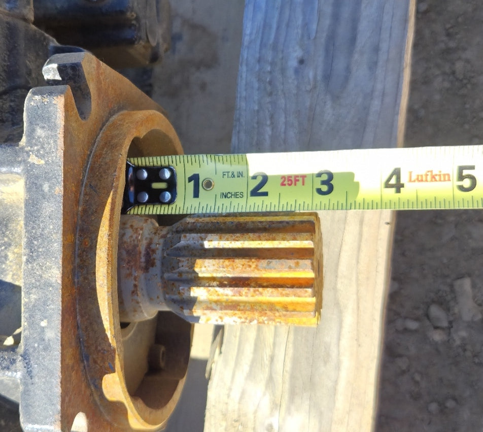 Tape measure extended along the splined shaft of the hydraulic pump showing approximately 1.5 inches of usable spline length.