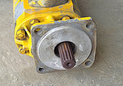 ]: Close-up of the pump's 14-tooth splined drive shaft showing slight surface oxidation.

