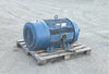 Front angle view of the large blue Siemens 200 HP electric motor on a pallet showing the ribbed cast iron body and cut power cables.