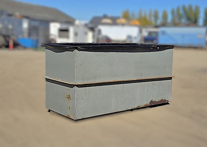  Front three-quarter view of the gray rectangular welded steel open-top tank showing the mid-height reinforcement rib and black overlapping top liner lip.
