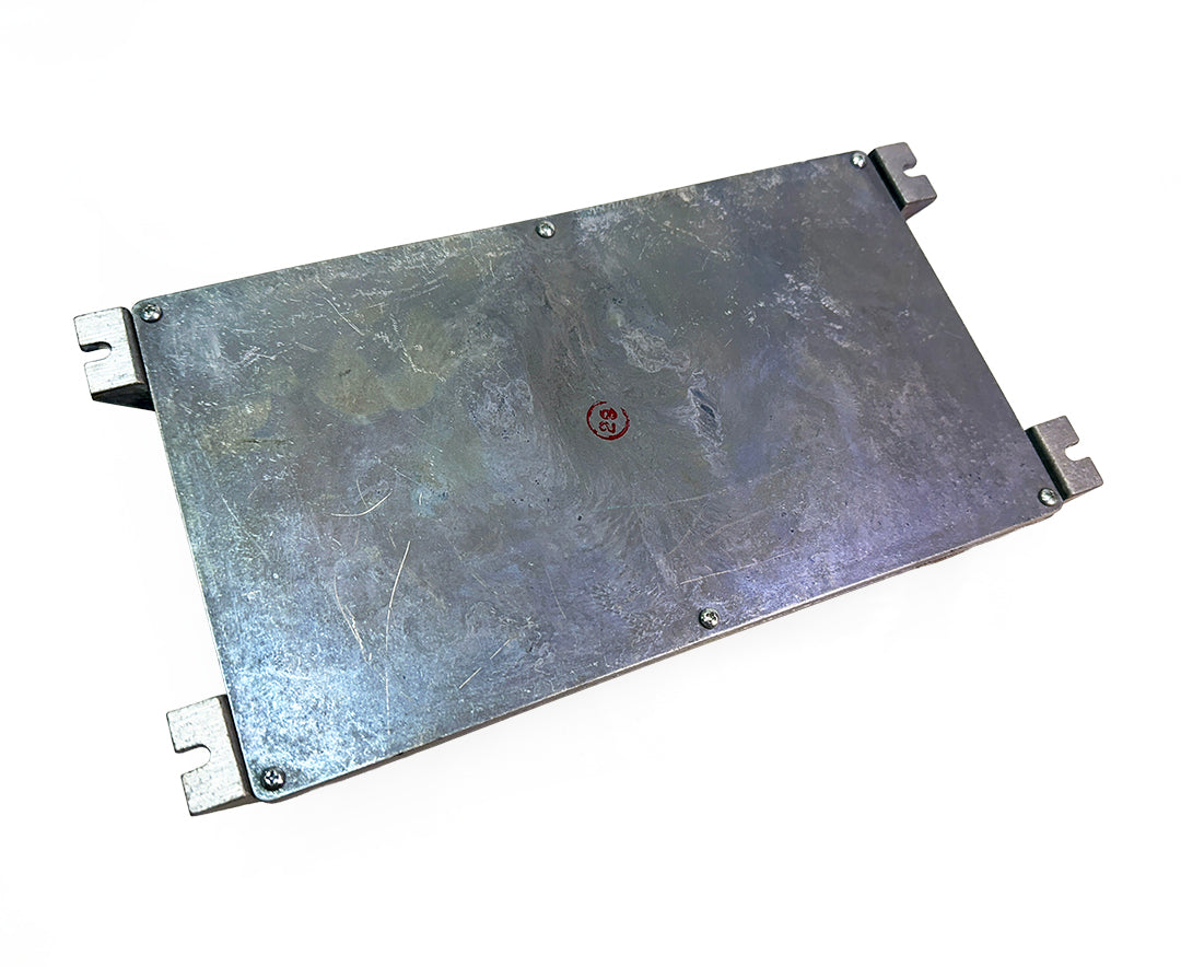 Back mounting plate of a CV-CCM-D Commercial Vehicle Controls multiplex module showing four corner brackets and inspection stamp.