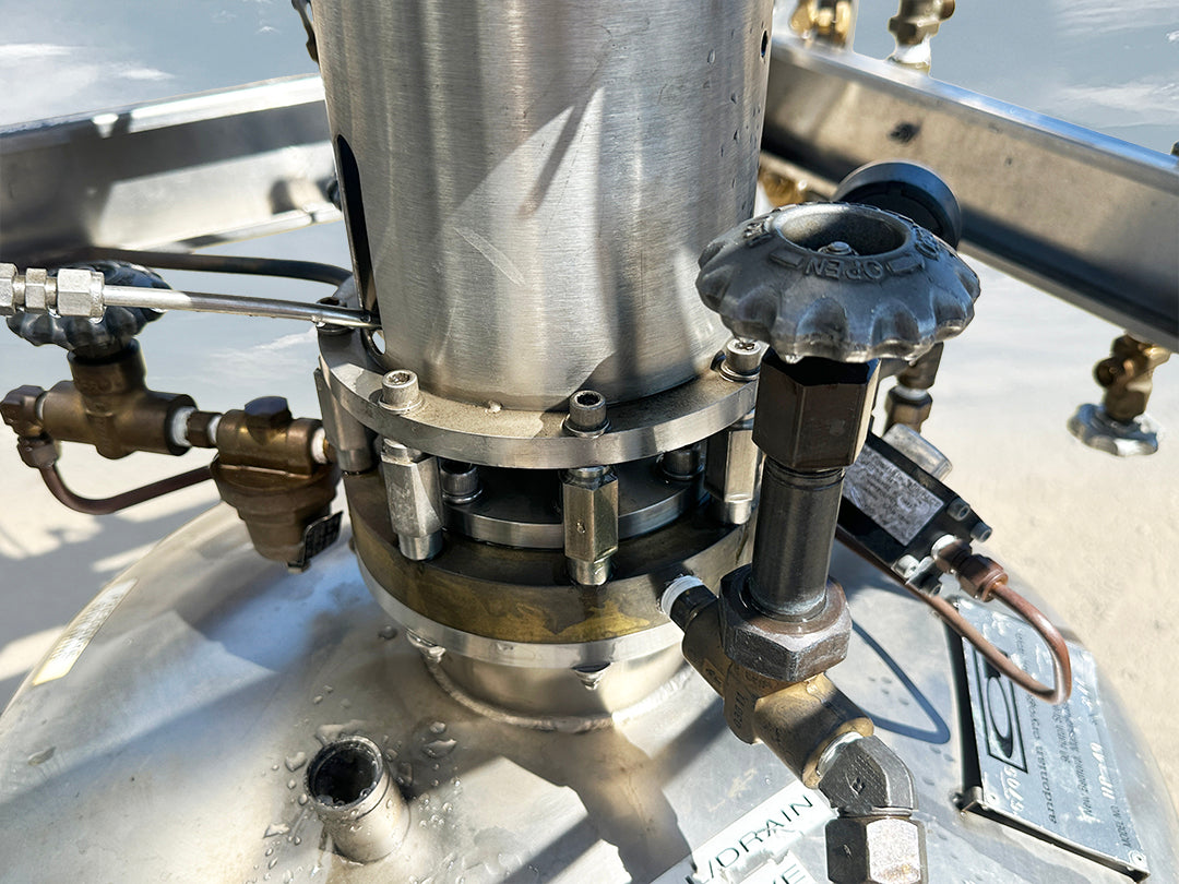 Pump Assembly]: Andonian Cryogenics HP-40 cryogenic pump module close up showing top flange and brass fittings.