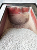 Abrasive Finishing Inc SuperQuiet Burr Bench vibratory tumbler internal tub view showing red ribbed urethane lining and grey ceramic stone tumbling media