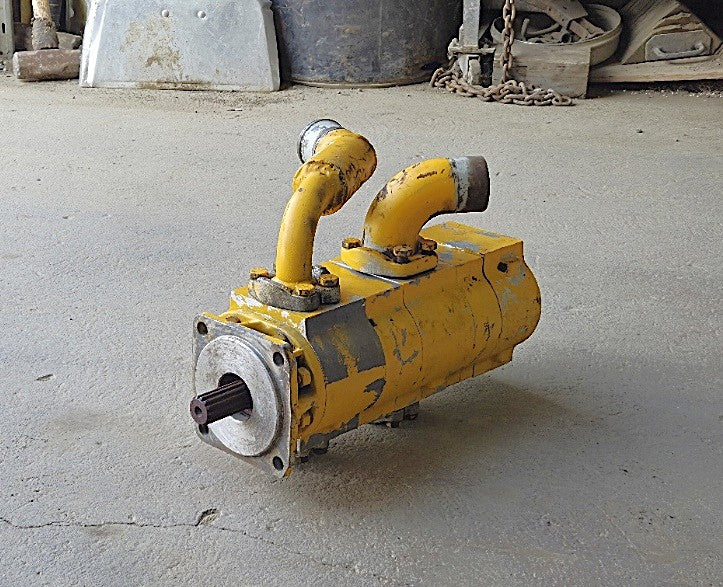 Opposite side profile of the triple-stage hydraulic pump detailing the heavy cast iron construction and section tie-bolts.
